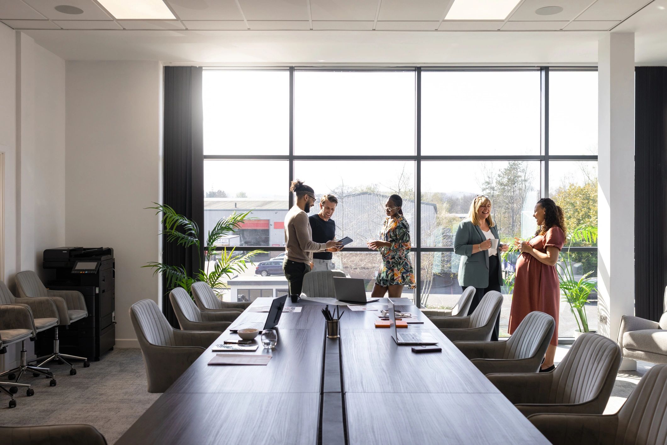 Business and technology professionals collaborating in a modern meeting space