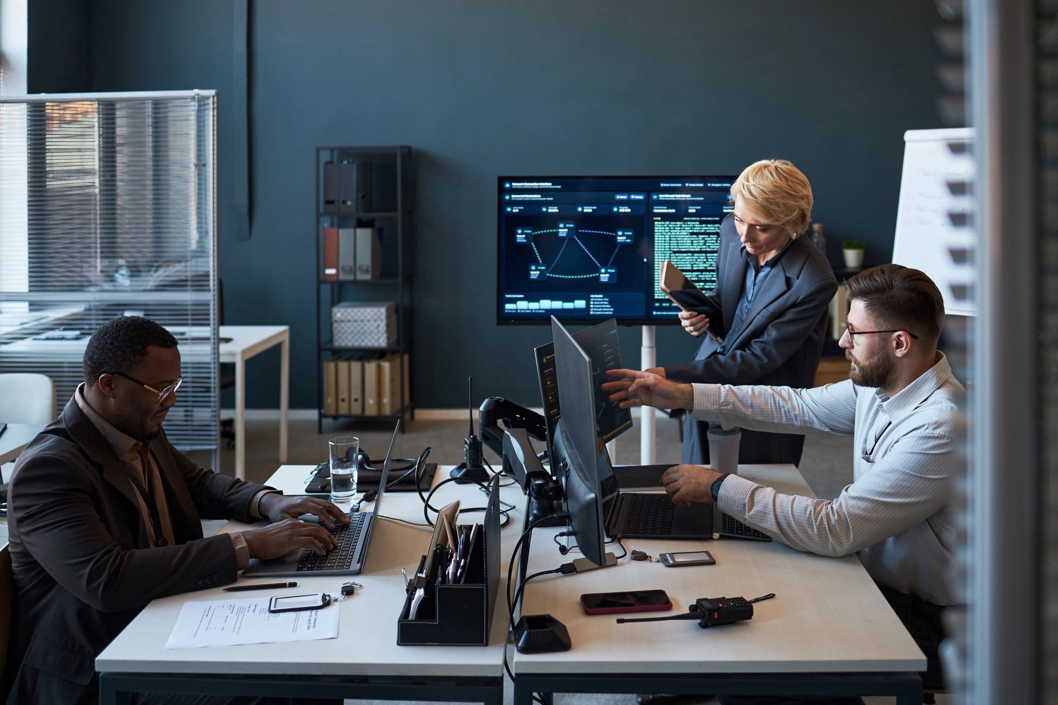 Technology leadership team reviewing dashboards in a modern office